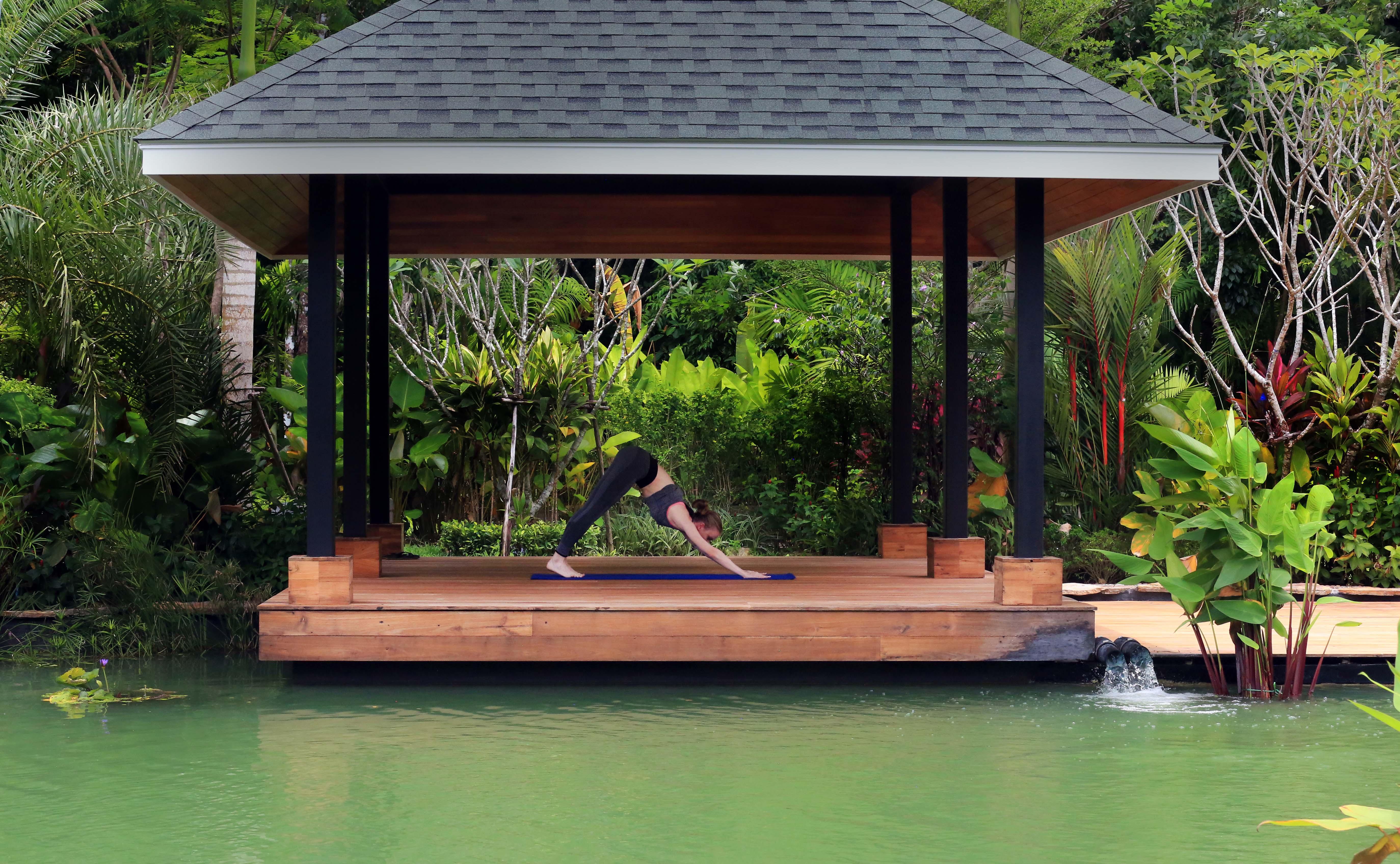 The Pavilions Phuket (Adults Only) Pantai Bang Tao Bagian luar foto A woman practicing yoga at the BANYAN TREE Spa